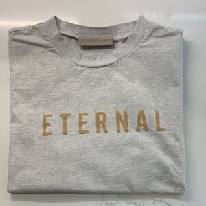 Essentials Fear of God Oatmeal T-Shirt with Gold 'ETERNAL' Print